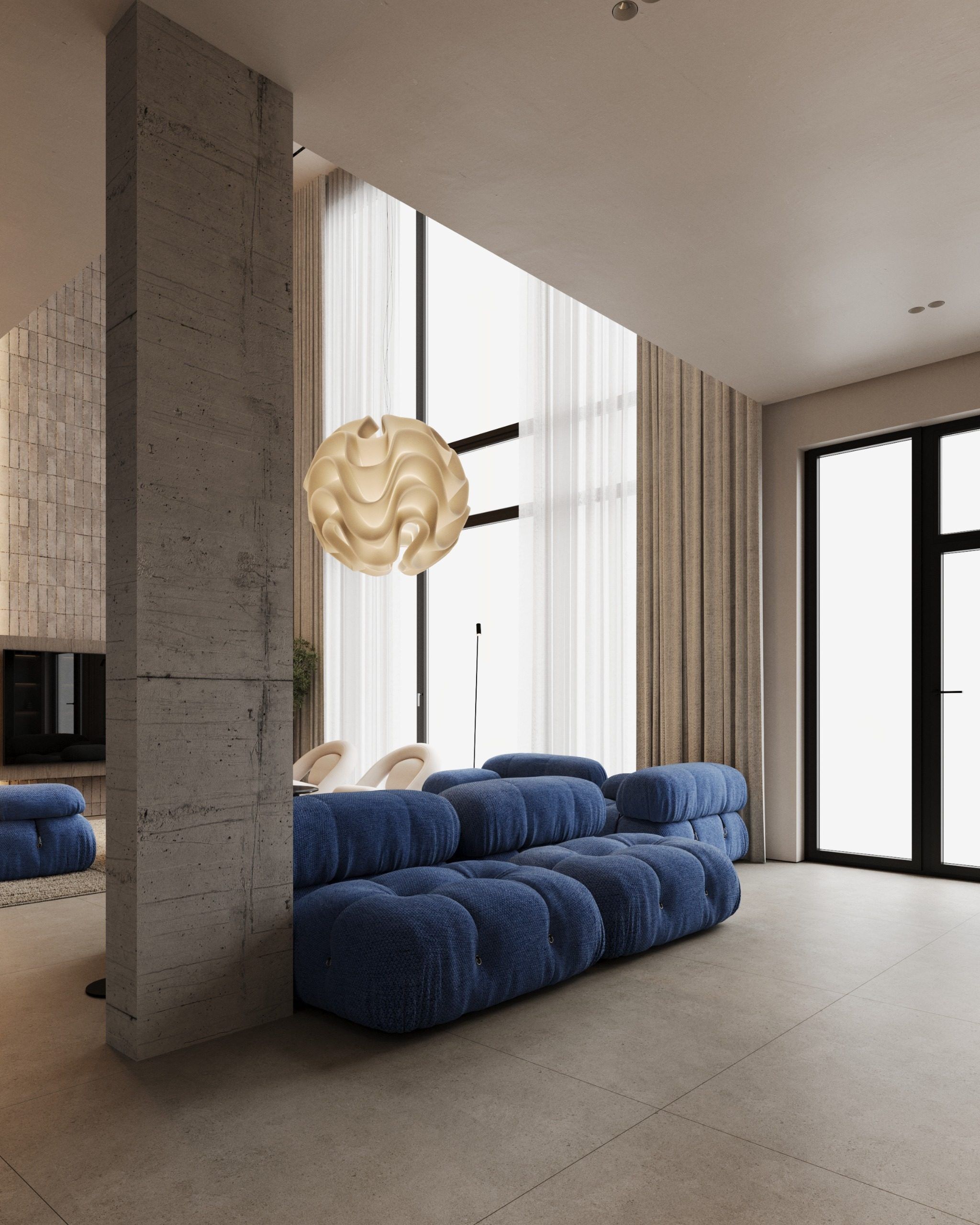 Blue modular sofa against concrete wall with natural light