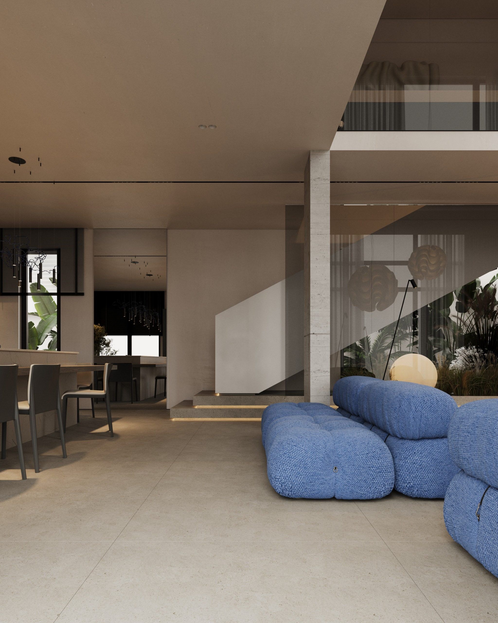 Open plan space with blue furniture and kitchen area