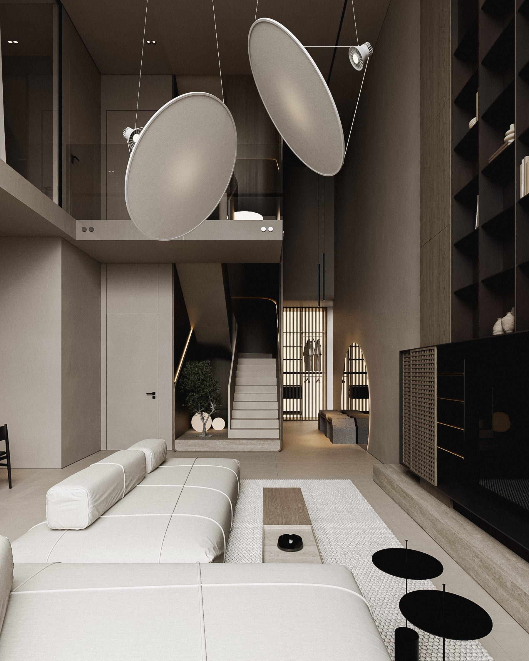 Entrance space with suspended lights, staircase and seating area