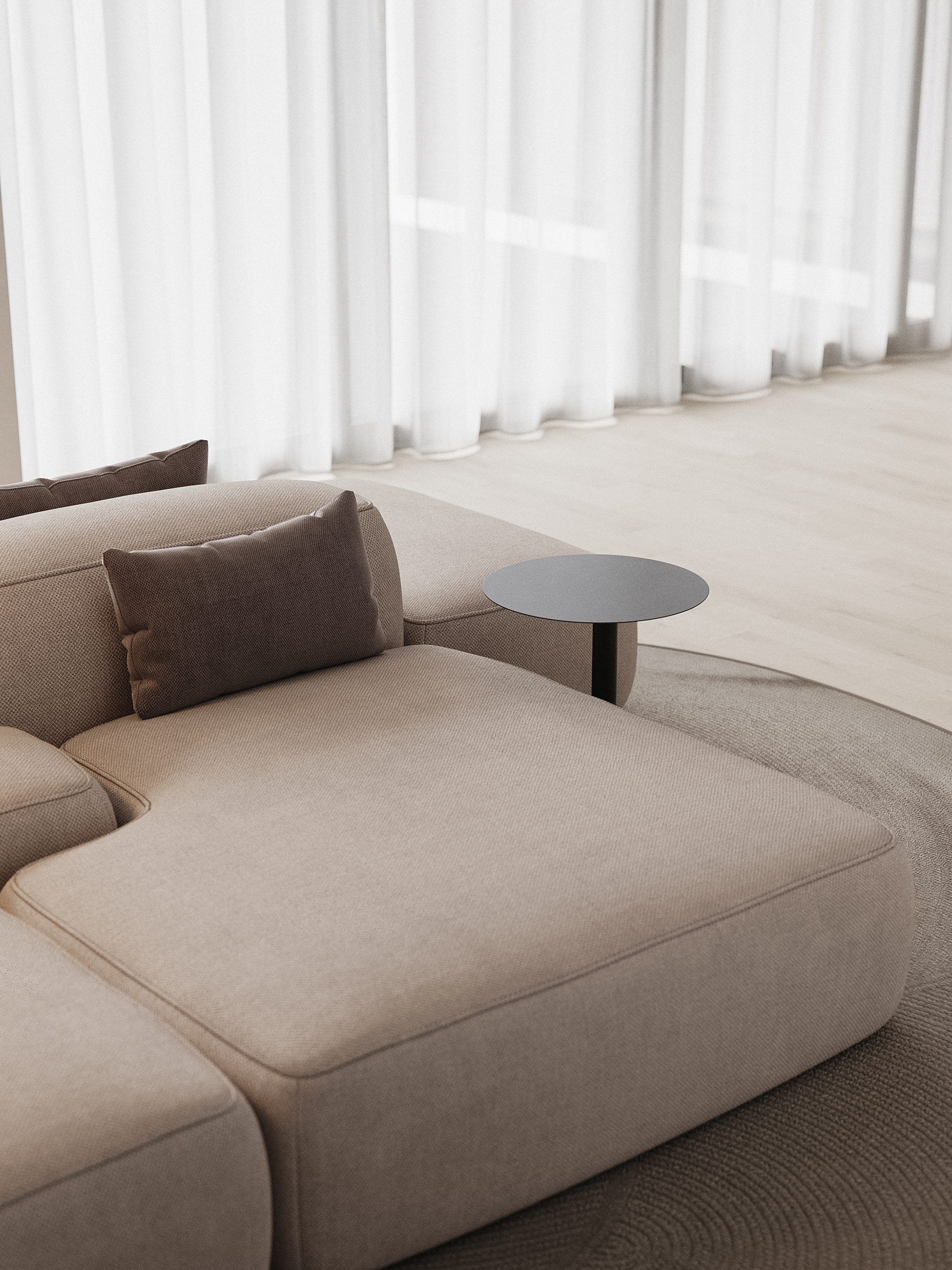Low sofa with pillow and concrete side table