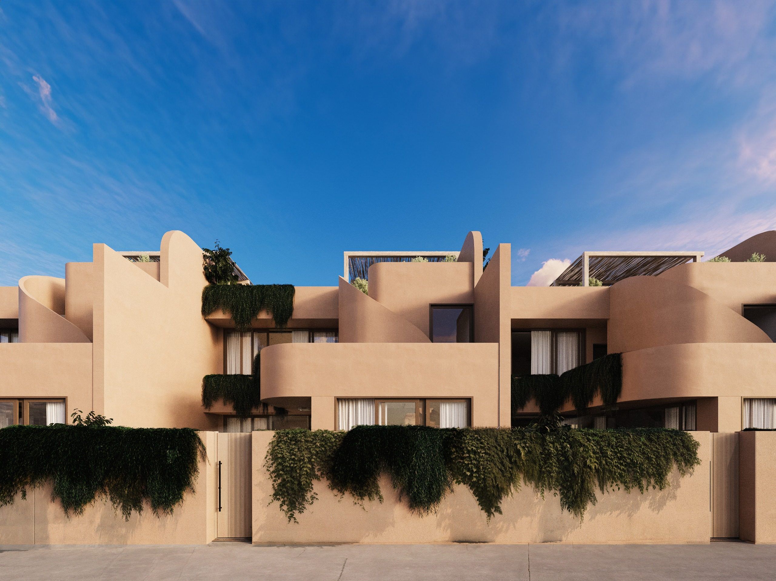 Residential complex facade with sand-colored walls and vertical greenery