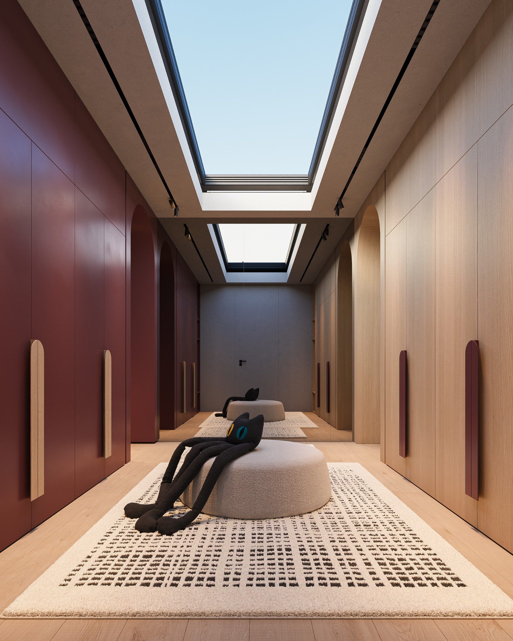 Long room with alternating burgundy and light panels, skylight in ceiling