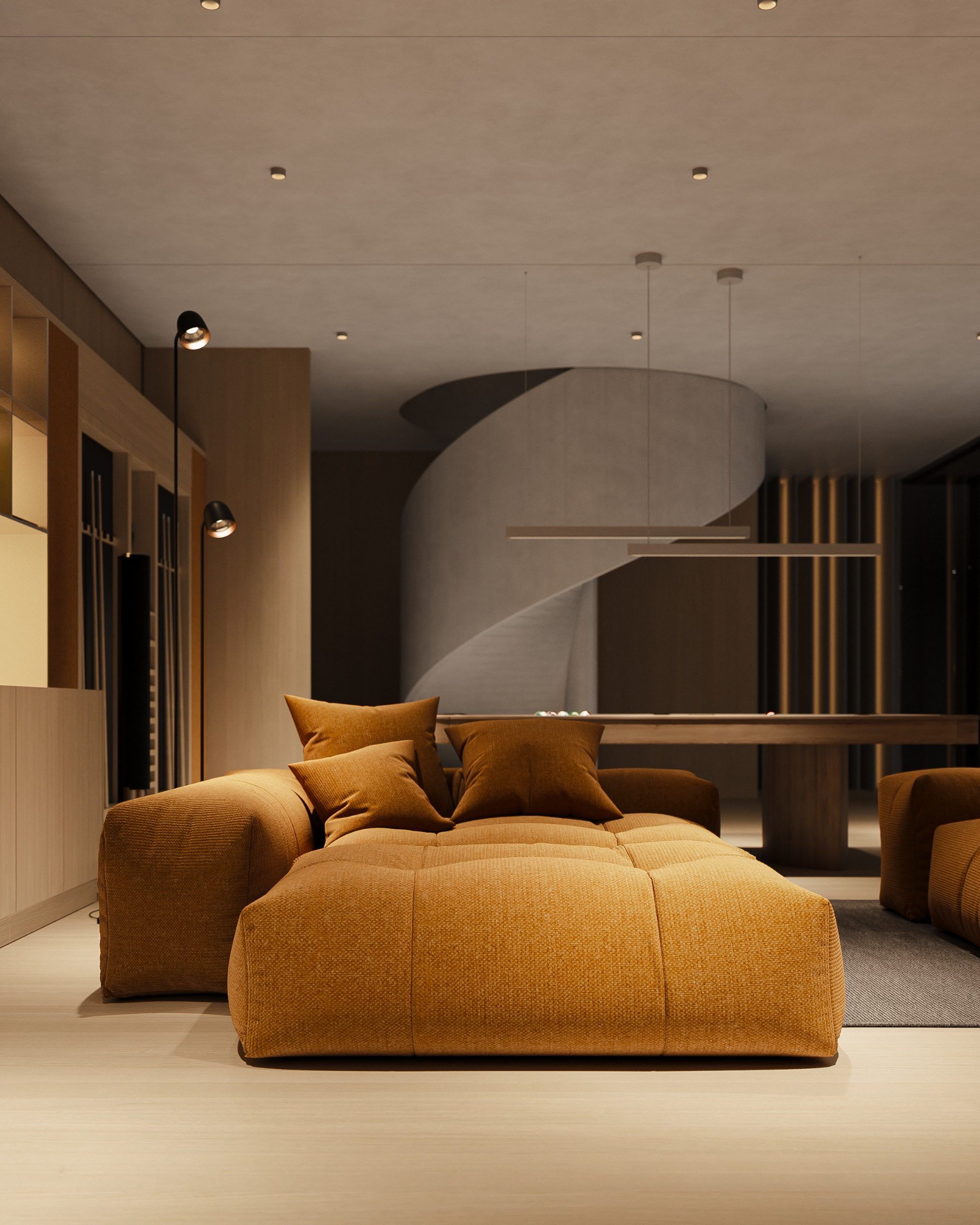 Living area with orange modular sofa and curved staircase