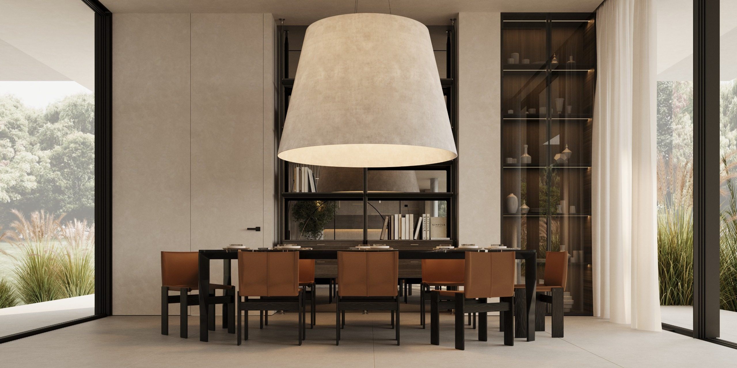Dining area beneath large sculptural pendant with wooden table and display cabinet