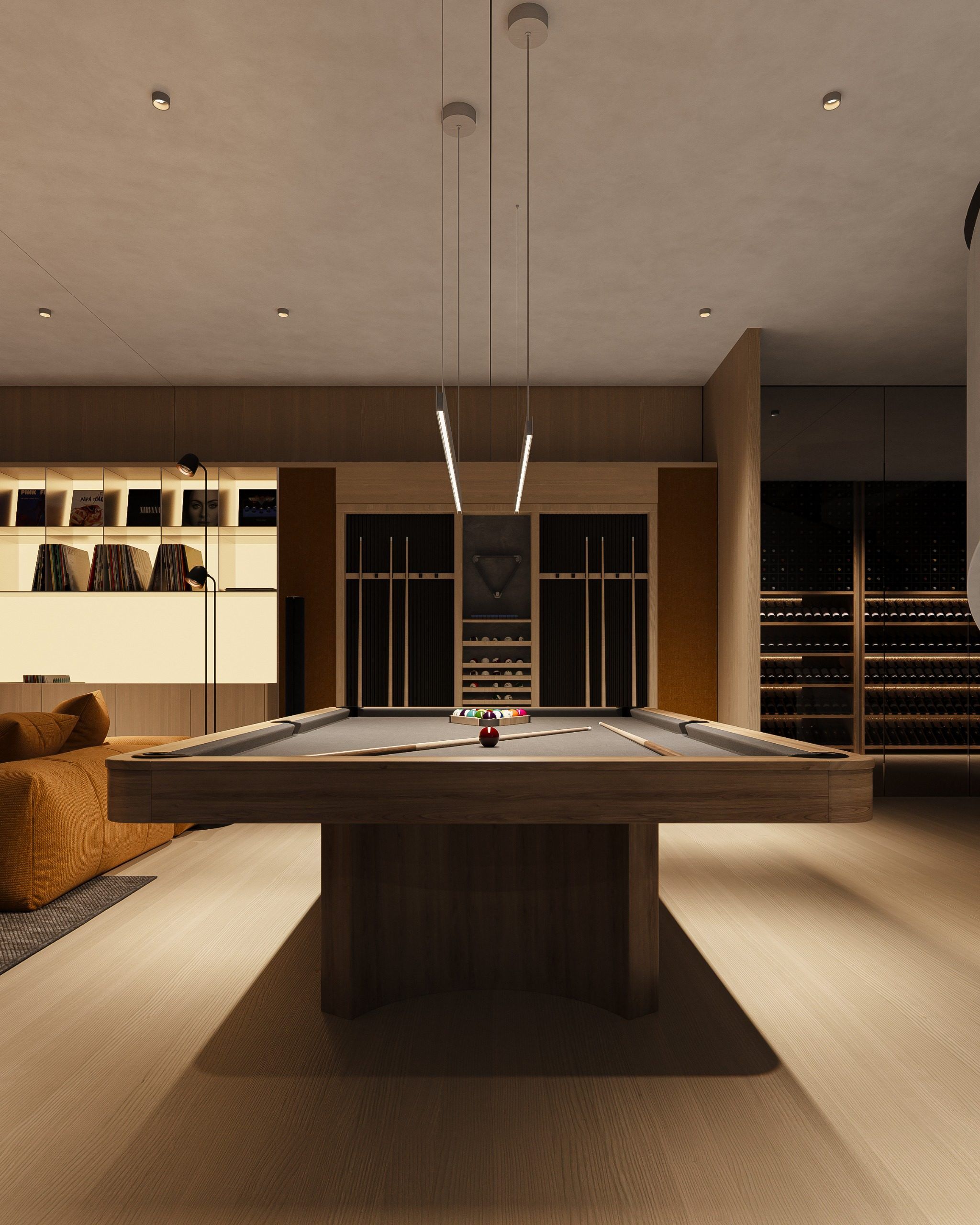 Billiard table in room center with shelving and lit cabinetry along walls