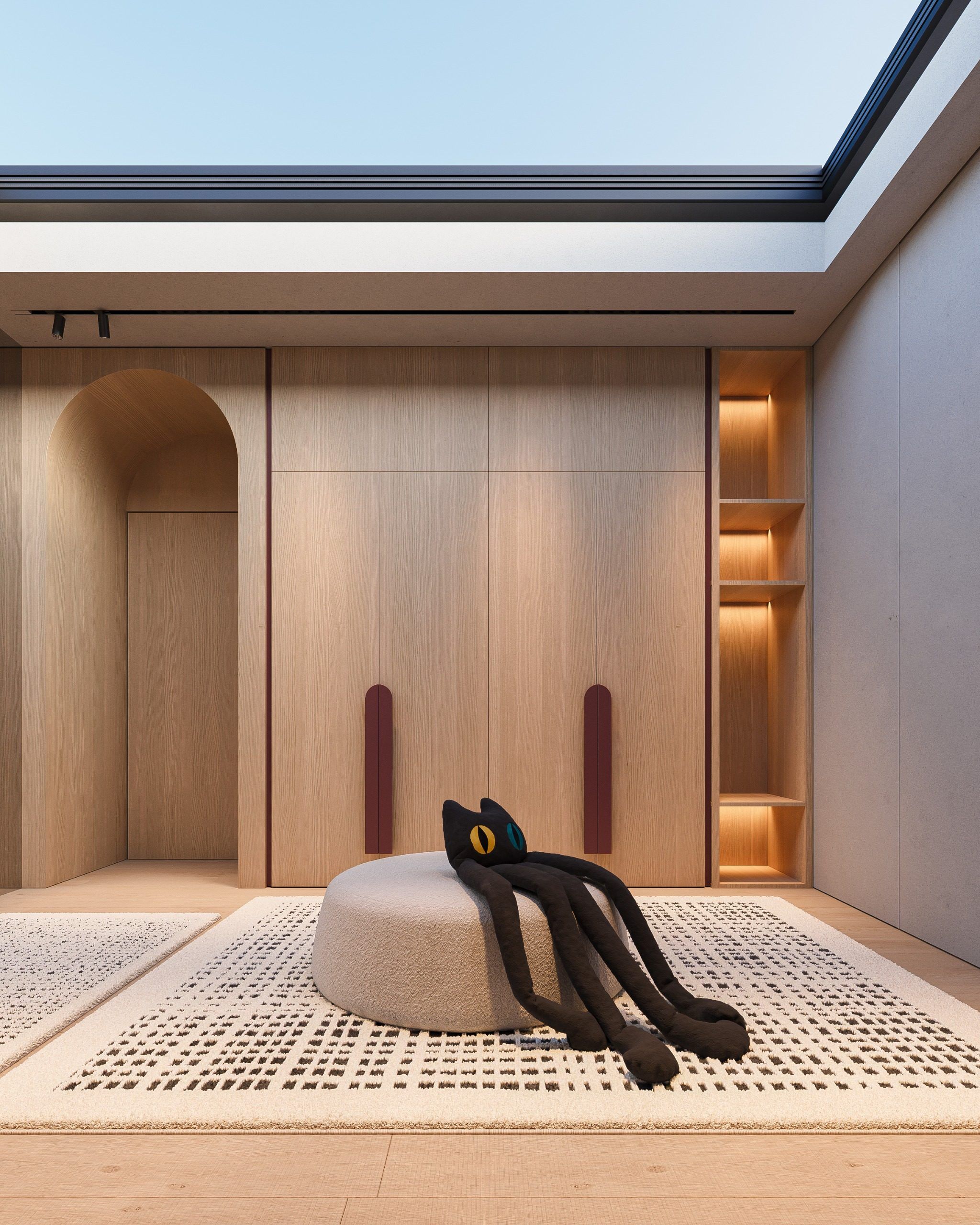 Walk-in closet with closed cabinetry, built-in lighting and round ottoman in center